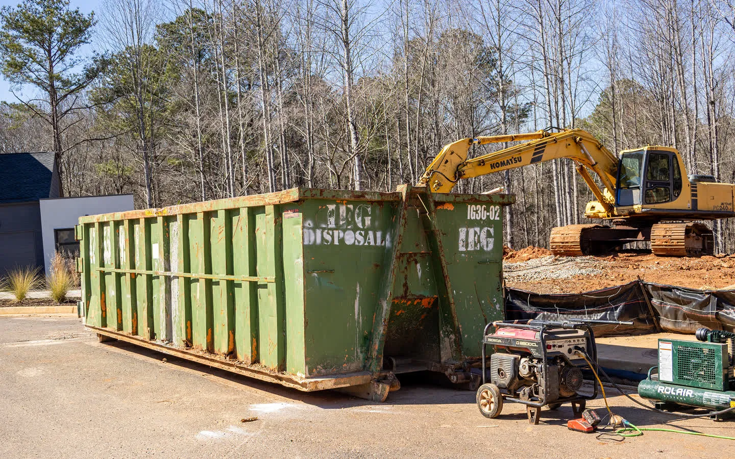 A couple placing an old couch in one of our dumpsters.