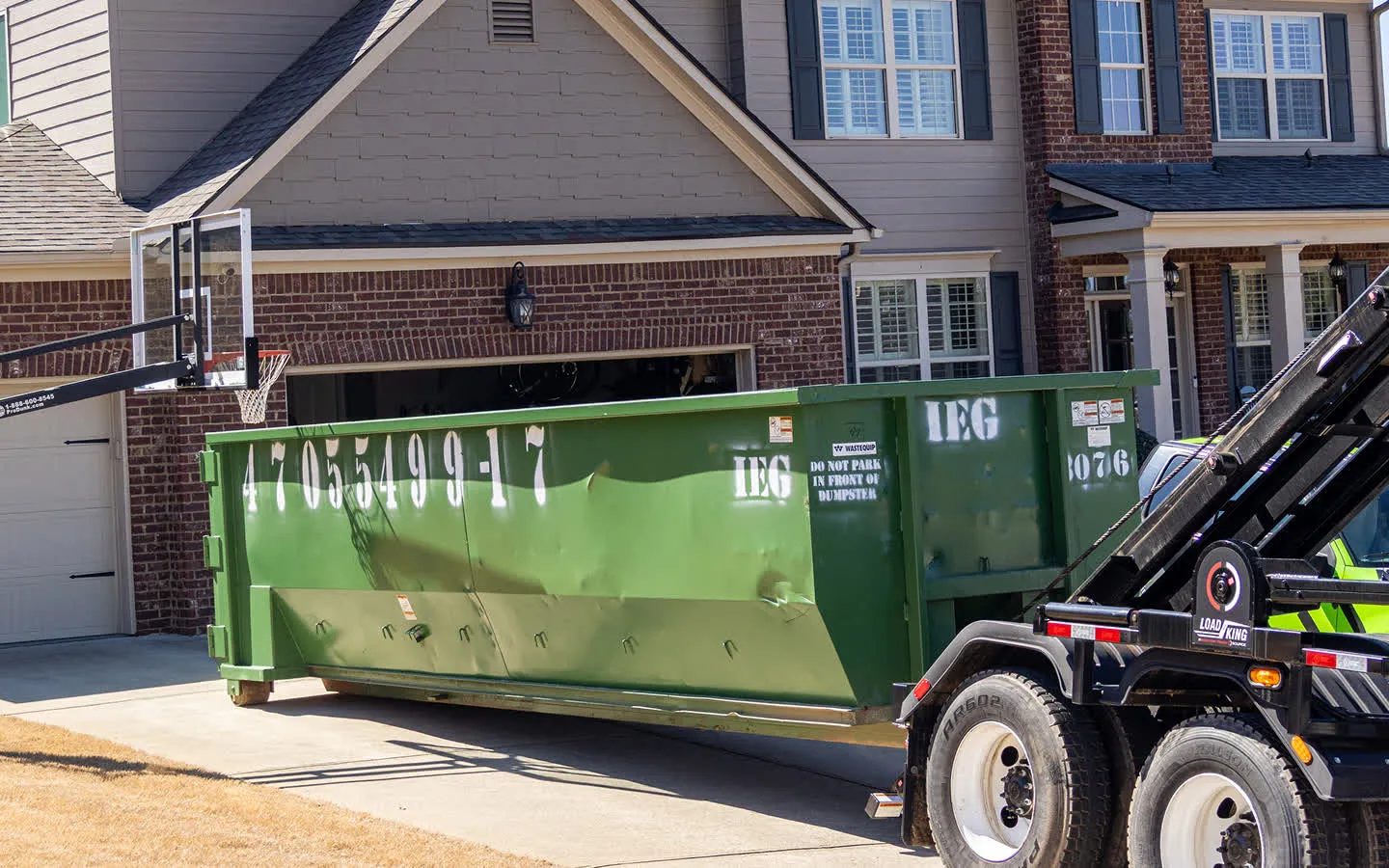 A couple placing an old couch in one of our dumpsters.