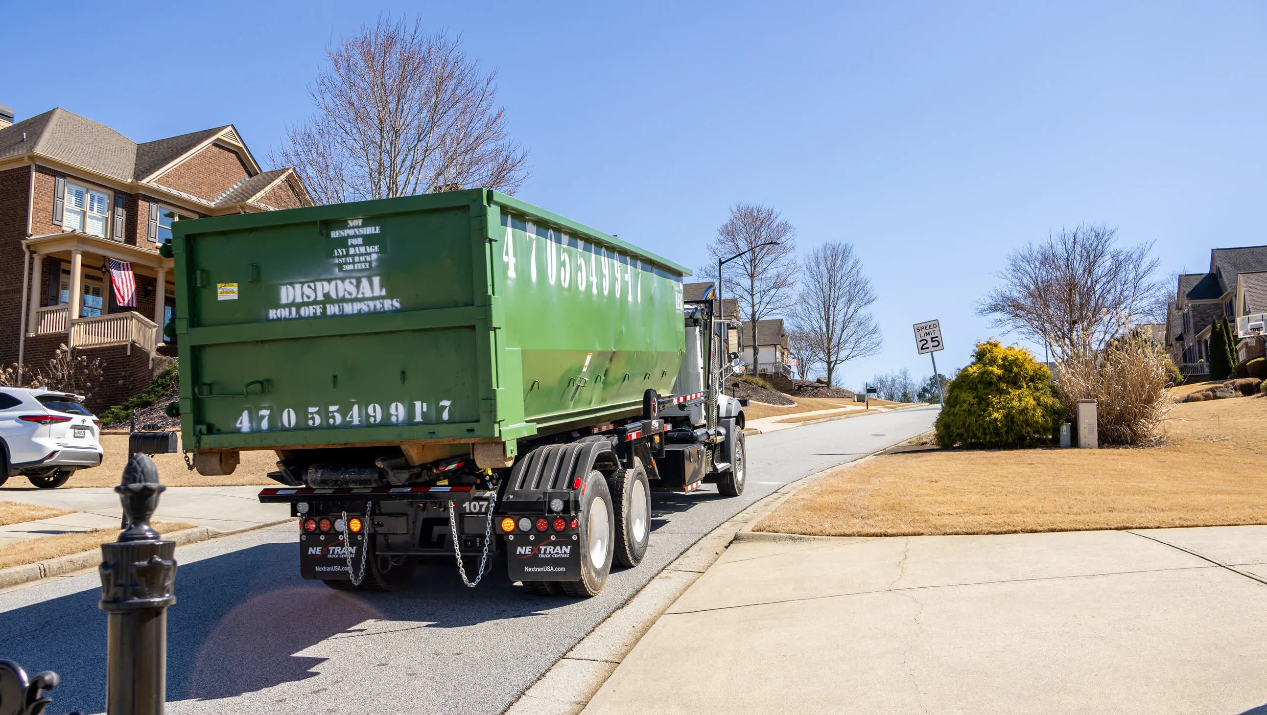 One of our dumpsters in front of a house.