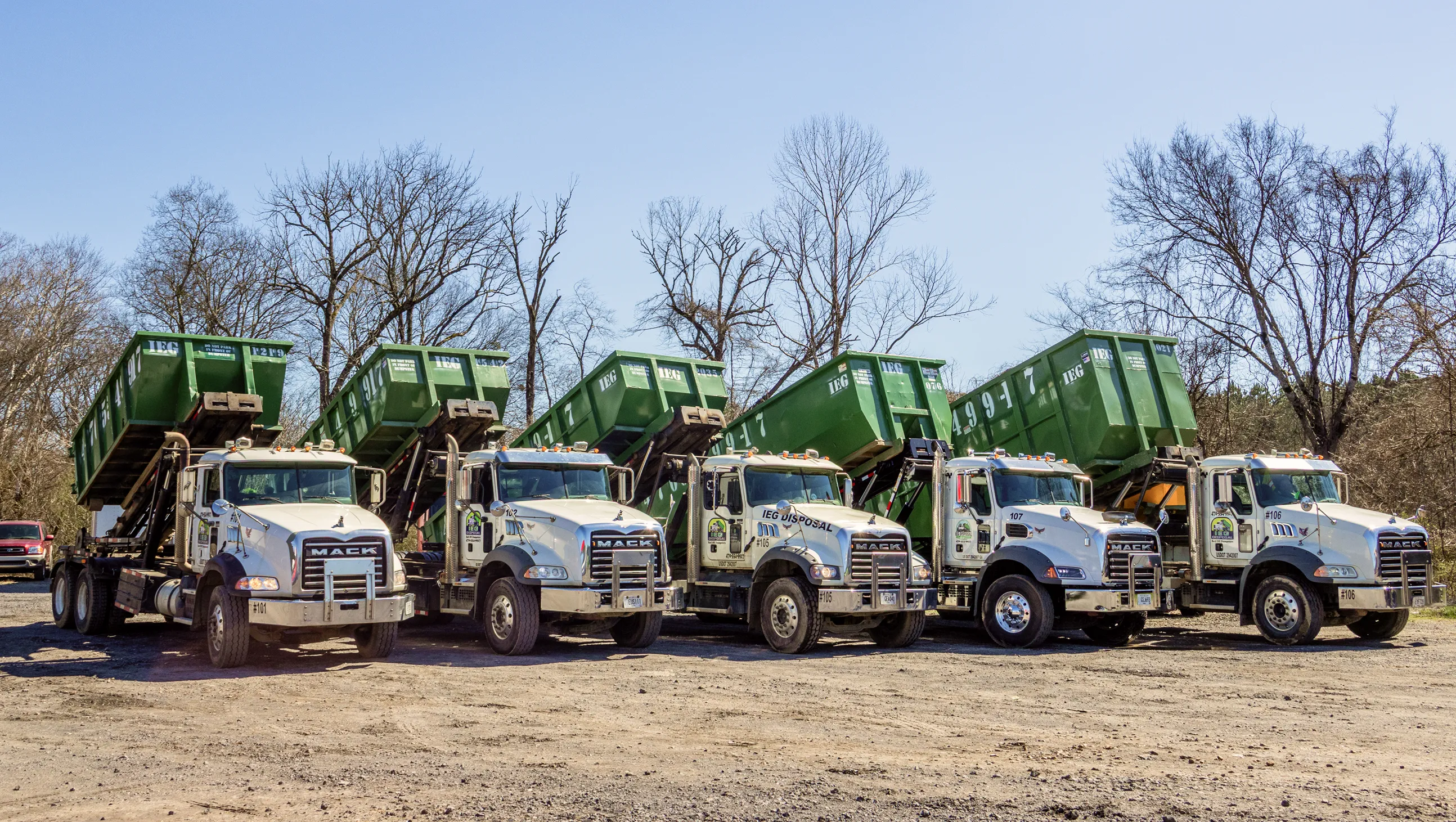 A truck unloading a dumpster in our yard